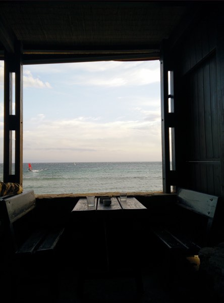 Window, sea and widsurfer